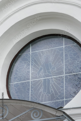 Arched church window with stained glass figure