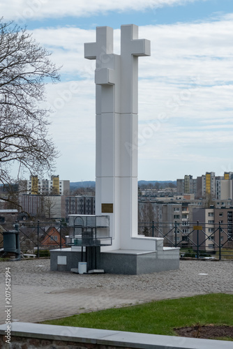 White cross monument above the city