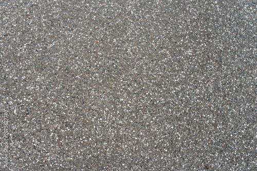 Fotografie Close-up of dark asphalt road surface with aggregate texture
