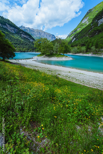 The view of Lake Tenno, a splendid alpine lake nestled between mountains and woods, near Lake Garda, near the town of Tenno, Trentino, Italy - May 2026