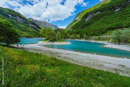 Quadro su tela The view of Lake Tenno, a splendid alpine lake nestled between mountains and woo