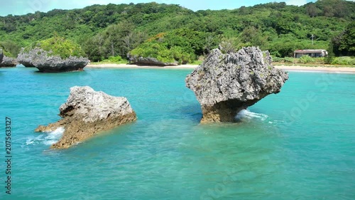 Aerial view of rock cliffs in the turquoise sea, Okinawa, Japan.