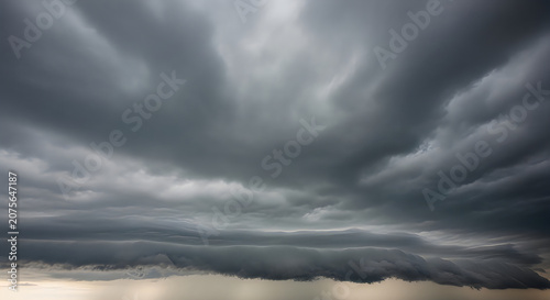 Dramatic Storm Clouds Over Sandy Beach with Sunlight Rays Breaking Through