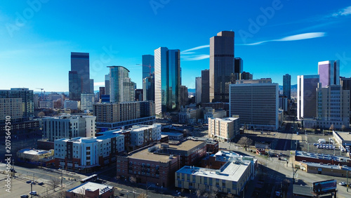 Massive commercial blocks oversee vacant lots adjacent to residential zones within Five Points district. Winter light casts elongated shadows over grey rooftops scattered across Denver, CO