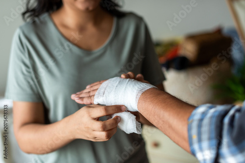 Photography Caring hands bandaging injured hand