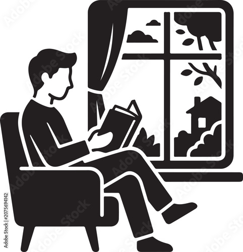 Man sitting in an armchair reading a book next to a scenic window view