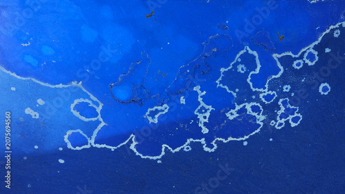 Photos Weathered blue painted metal texture with visible signs of sun exposure, fading,