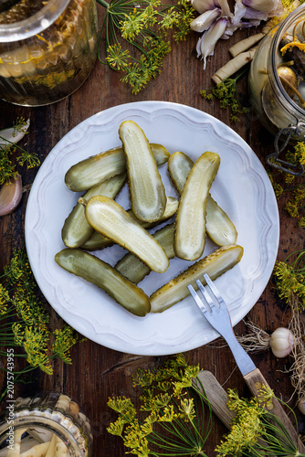 Traditional pickled cucumbers, pickled using the natural fermentation method, on a plate, top view