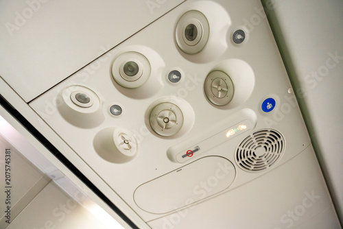 Air conditioning on an airplane and a flight attendant call button. High quality photo
