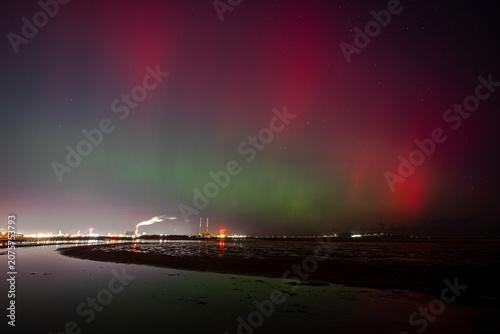 The Northern Lights in Dublin, Ireland. Red lights above the Poolbeg Chimneys in Dublin Bay