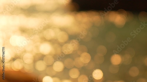 Bokeh sunset water shimmering reflections on a calm surface create a peaceful and dreamy abstract background for creative projects
