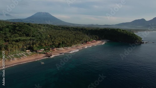 Aerial View of Virgin Beach Coastline with Green Cliffs, Blue Ocean and Volcanoes in Bali