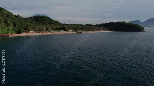 Aerial View of Virgin Beach Coastline with Green Cliffs, Blue Ocean and Volcanoes in Bali