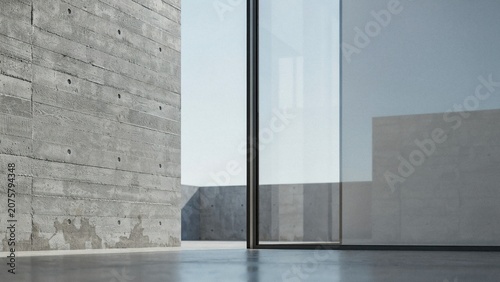 Concrete wall stands beside a large glass window in a minimalist architectural space under bright light.