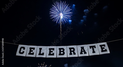 Bright nighttime pyrotechnics illuminate a banner spelling out a festive message
