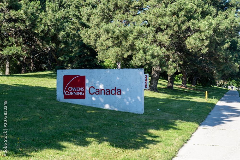 Obraz premium Toronto, Canada - June 27, 2026: The sign for Owens Corning Canada on McNicoll Ave in Scarborough, Toronto, Canada. Owens Corning is an American company that develops and produces insulation, roofing
