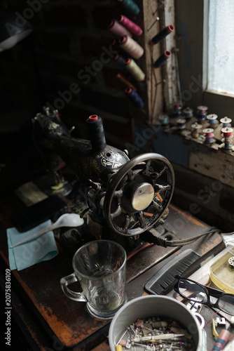 Rustic workshop with a vintage sewing machine, symbolizing enduring craftsmanship and the dedicated creative process of in textile arts
