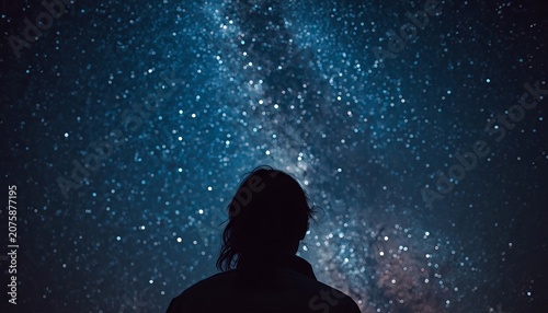 Silhouette of a woman gazing at a vibrant starry night sky filled with glowing constellations capturing a sense of profound wonder