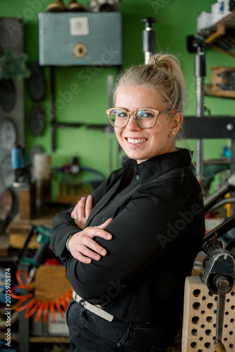Entrepreneur woman smiling crossing arms at workshop