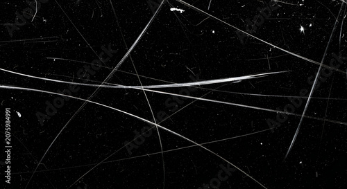 Distressed vintage film texture featuring sharp white scratch marks and dust particles scattered across a deep dark black background surface
