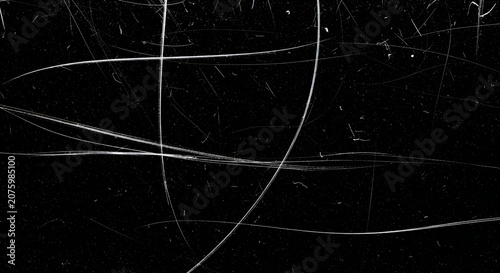 Distressed vintage film texture featuring white scratches and dust particles on a solid black background for professional artistic overlay effects
