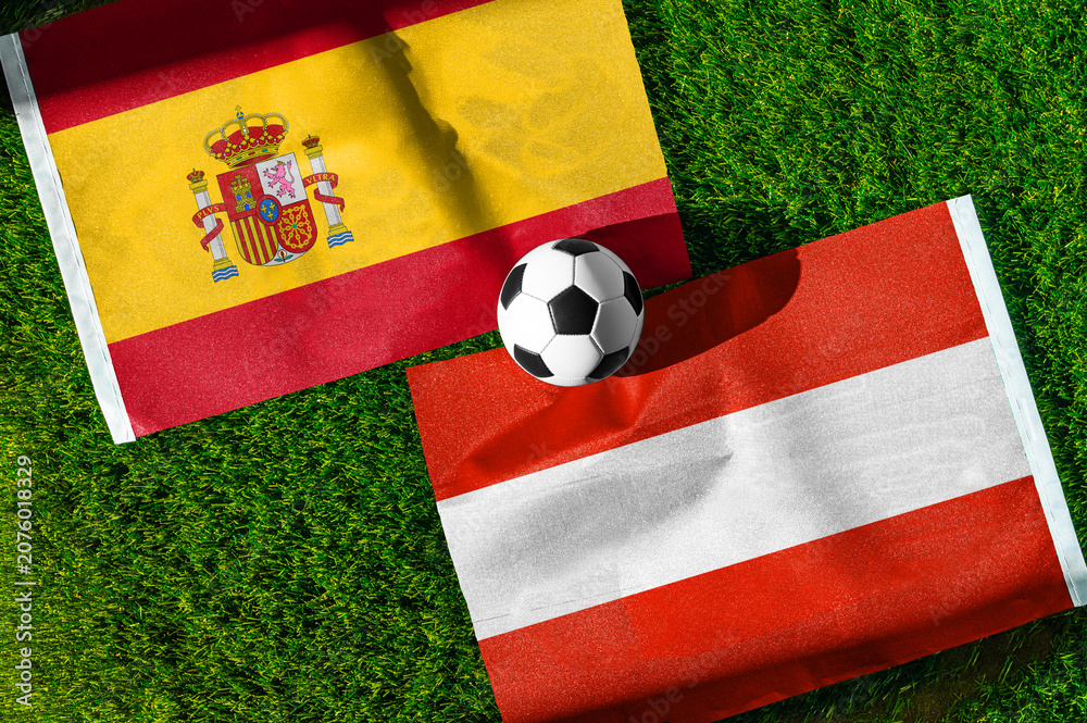 Obraz premium Spain vs Austria, national flags before international football tournament Round of 32 match, football on green grass with goal in the background, Inglewood, California, USA, July 2, 2026