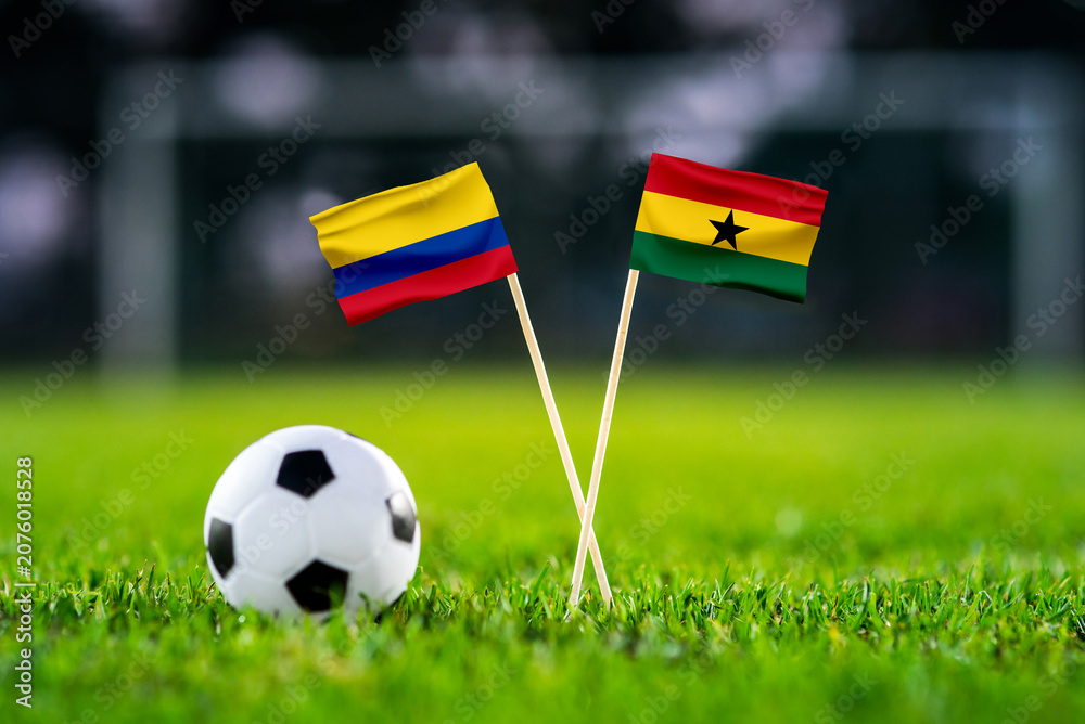 Obraz premium Colombia vs Ghana, national flags before international football tournament Round of 32 match, football on green grass with goal in the background, Kansas City, Missouri, USA, July 3, 2026