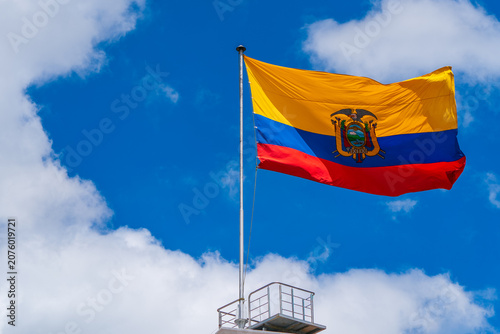 Ecuadorian national flag waving above the Presidential Palace in Quito, Ecuador