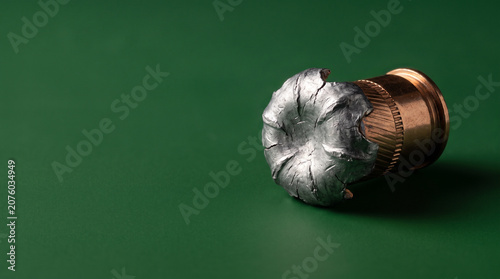 Recovered fired bullet deformed nose macro forensic ballistic green.