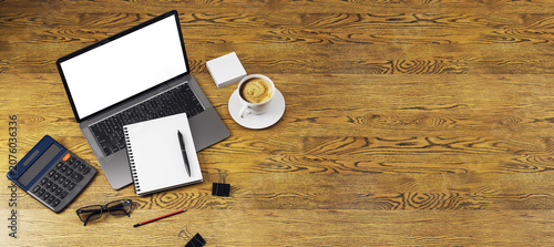 Workspace tabletop with laptop, notebook, calculator, glasses, pencil, clips ...
