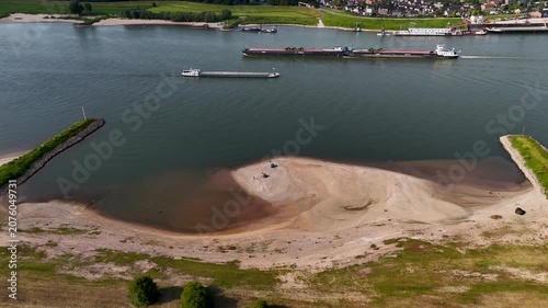 Aerial view of cargo ships navigating a drought-stricken river