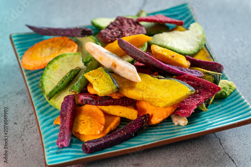 Mixed vegetable chips snack on blue plate