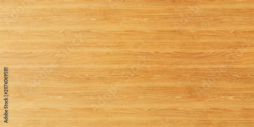 A warm, golden wood grain texture with subtle horizontal lines and natural imperfections, suggesting a polished surface or rustic material.
