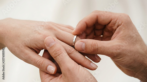 Groom Placing a Classic Wedding Band on the Bride's Finger During a Romantic Marriage Ceremony Moment