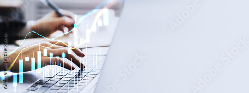Bild auf Leinwand Hands typing on laptop with glowing financial trading charts and currency graph overlays illustrating market analysis and growth trends