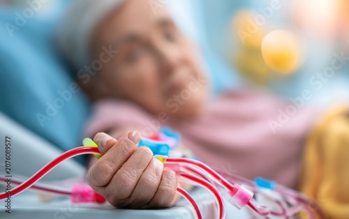 Elderly Woman Receiving Medical Treatment with Monitoring Equipment