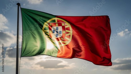 Waving Flag of Portugal Against a Blue Sky Background.