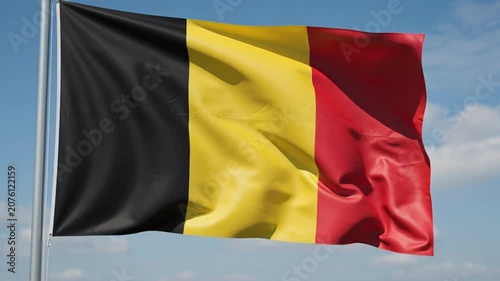 Belgian National Flag Waving in the Wind Against a Blue Sky.