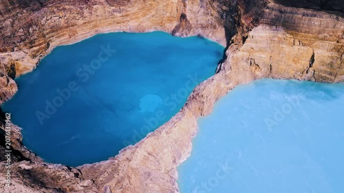 High Drone Angle View of Two Different Colored Volcanic Caldera Basins. Aerial Shot of Beautiful Indonesian Landmark in Wilderness Surrounded by High Mountain Cliff Walls at Daytime 4k