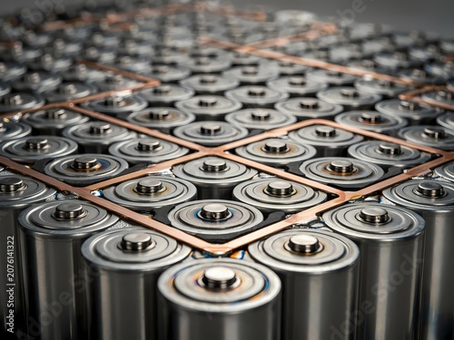 Rows of silver metal cylindrical batteries with copper connections  electronic components