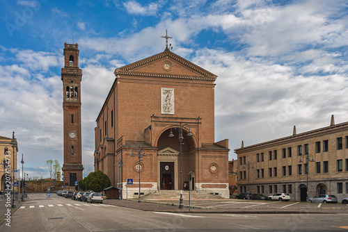 view of the Cathedral of San Mauro with the high bell tower in Cavarzere, Venice, Italy