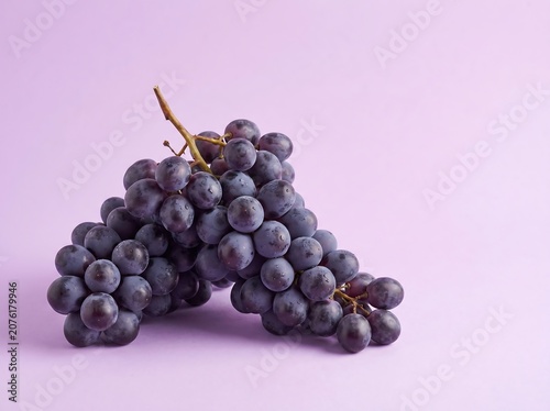 Grapes on pastel purple Background Natural Food Concept