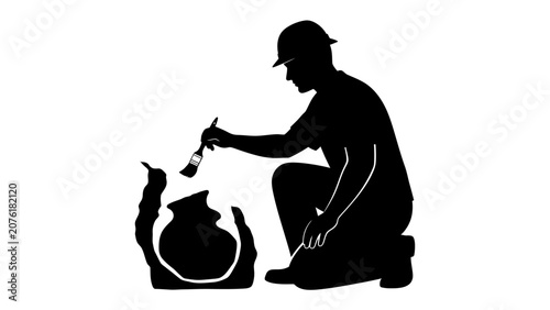 Konstfotografi Archaeologist Digging Pot: A silhouetted archaeologist in a hard hat meticulously brushes dirt off a fragmented ancient pot, revealing history beneath the earth's surface