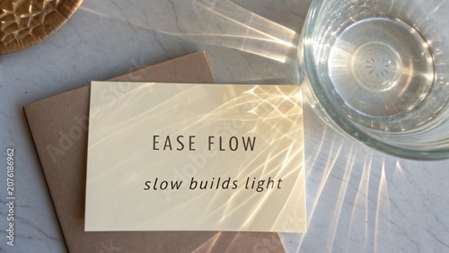 Calm and Tranquil Setting with Inspirational Quote on Card Surrounded by Natural Elements and Reflections of Light