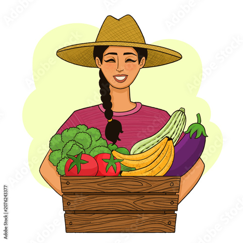 A girl wearing a hat carries a box of harvested tropical fruits.