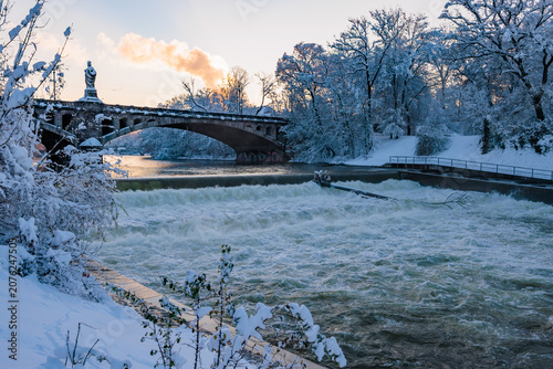 Beautiful winter landscape with a river and a bridge in the background
