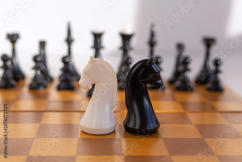 Fotografie Chess Knights Confrontation on Wooden Board