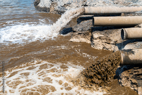 Принти на полотні Dirty wastewater flowing from pipes into a pond, water pollution, dirty water, e