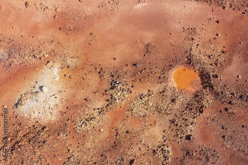 Little pool and extremely mineral-rich ground in the area of the Rio Tinto mines, the colour is caused by oxidised iron minerals, aerial view, drone shot, Huelva province, Andalusia, Spain