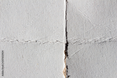 Bild auf Leinwand White paper surface displaying folds, wrinkles, and deep creases forming a textured background